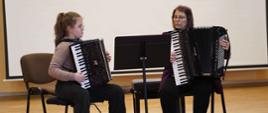 zdjęcie przedstawia prowadzącą warsztaty grającą w duecie na akordeonach z uczennicą młodszej klasy