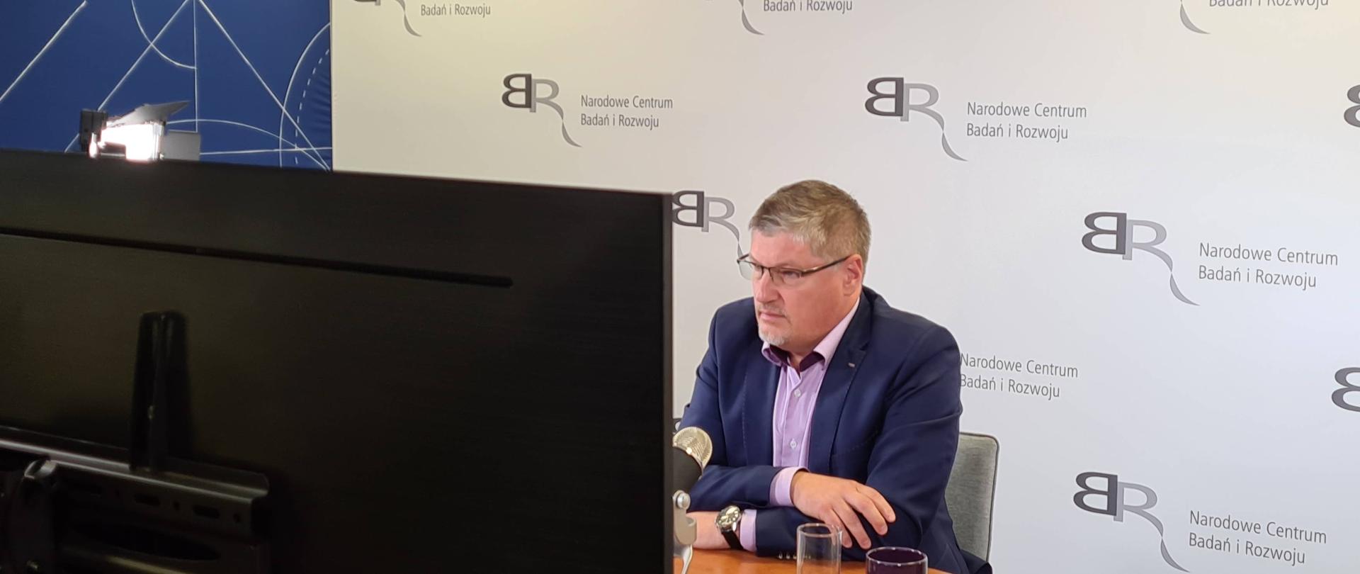 Przemysław Kurczewski, zastępca dyrektora NCBR bierze udział online w debacie PKP „Nowe technologie, nowe rozwiązania na kolei”, ze studia NCBR.