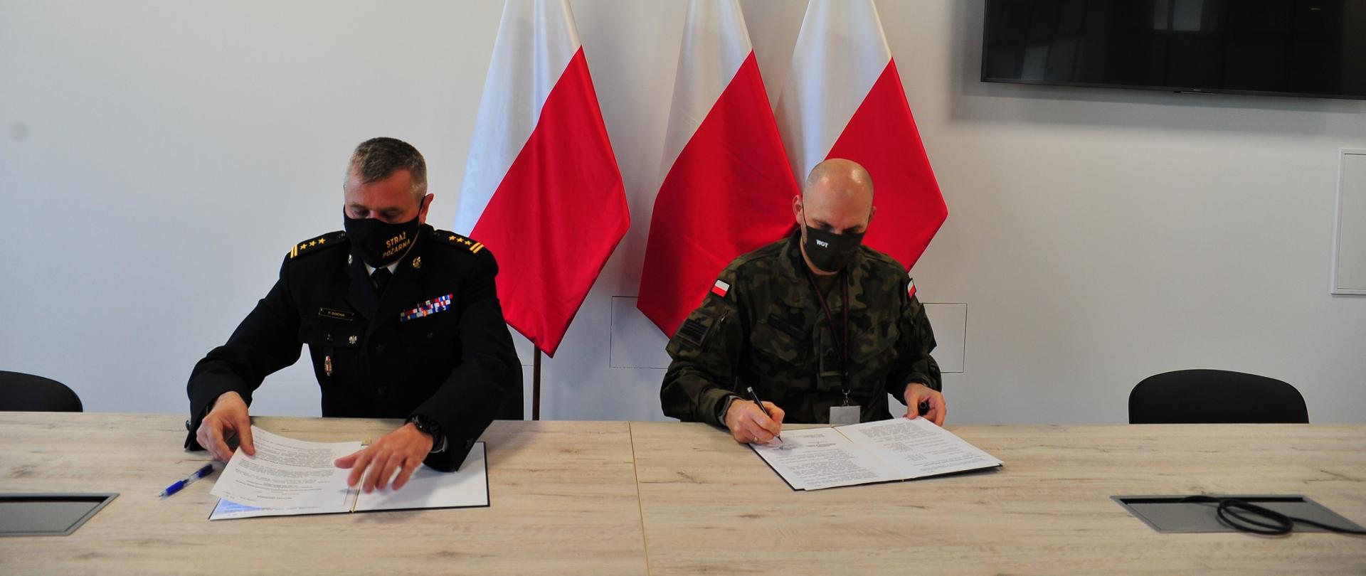 Pomorskie komendant wojewódzki Państwowej Straży Pożarnej oraz dowódca 7 Pomorskiej Brygady Obrony Terytorialnej podpisują notatkę uzgodnień w sprawie gotowości mobilizacyjnej i bojowej w województwie pomorskim.
