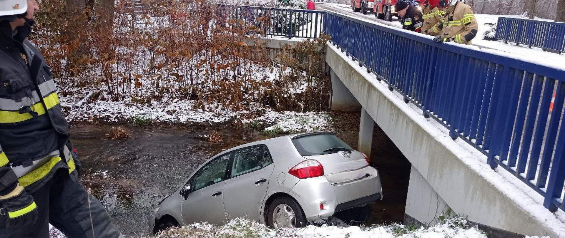 Pojazd który minął most i wjechał przodem do rzeki.