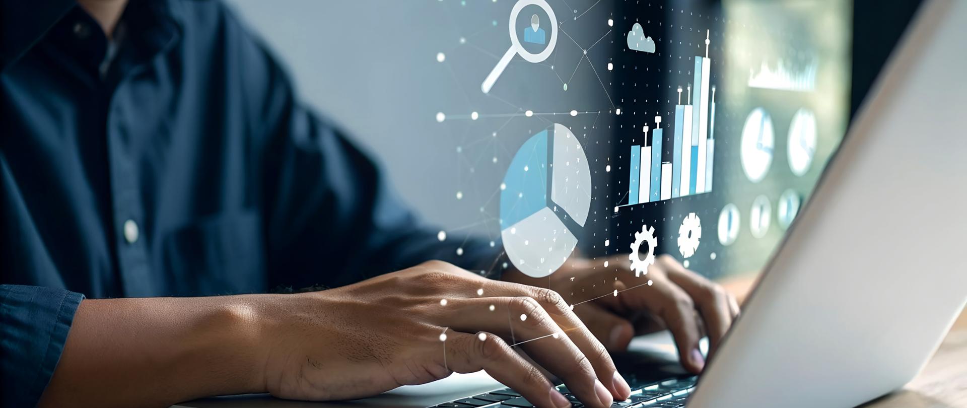 Ręce na klawiaturze laptopa, na obrazek nałożone półprzezroczyste wykresy