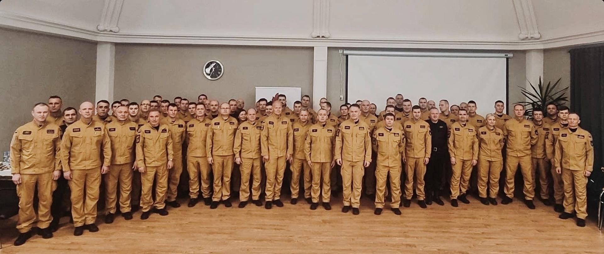 Strażacy stoją obok siebie w rzędach.