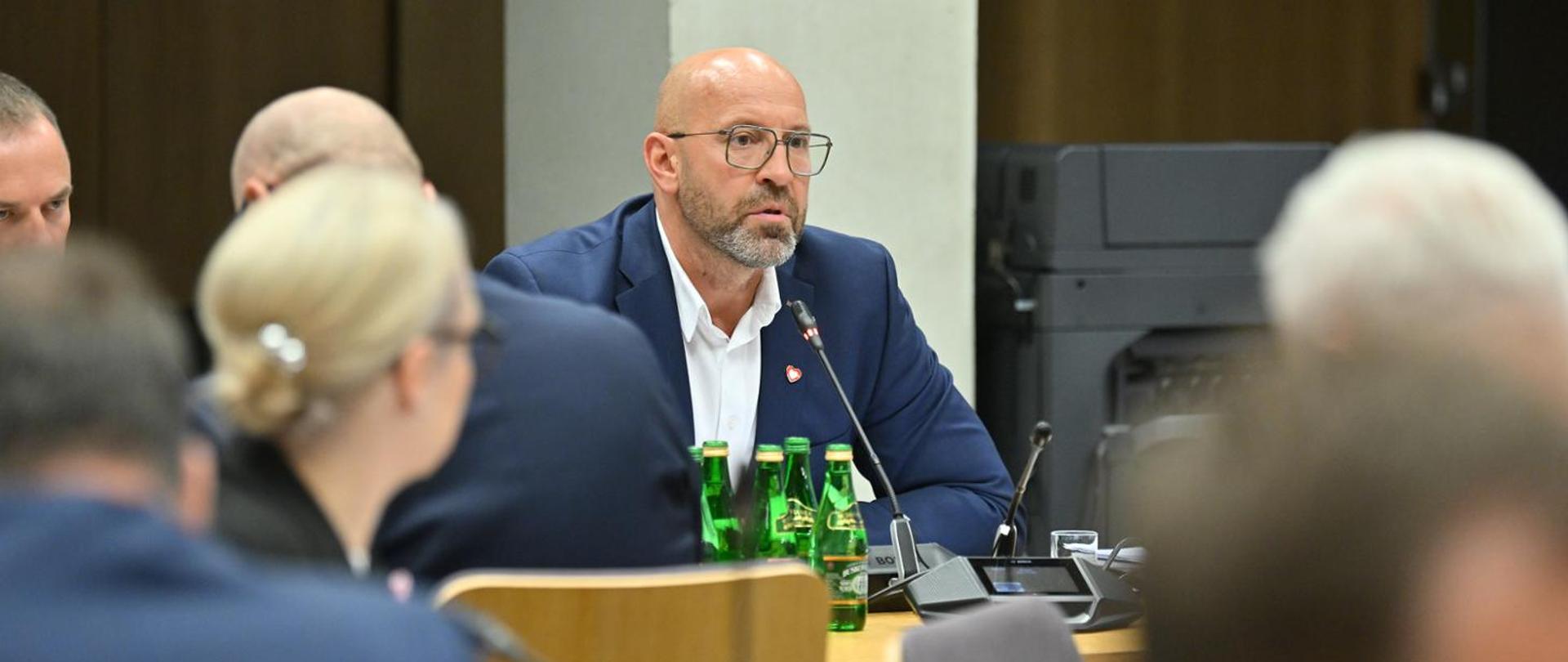 Picture showing Minister of Sport and Tourism Jakub Rutnicki sitting at the table. Other people visible around him.