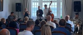 Jazz concert of the Mellem–Lawiracje–Verdener project at the Embassy of the Republic of Poland in Copenhagen. Musicians perform before a large audience.