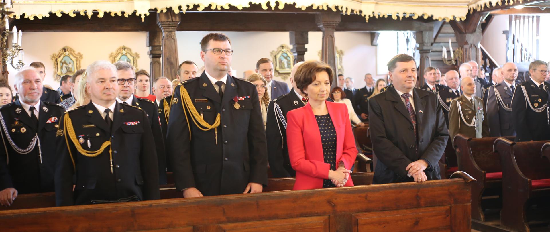 strażacy stoją w kościele 