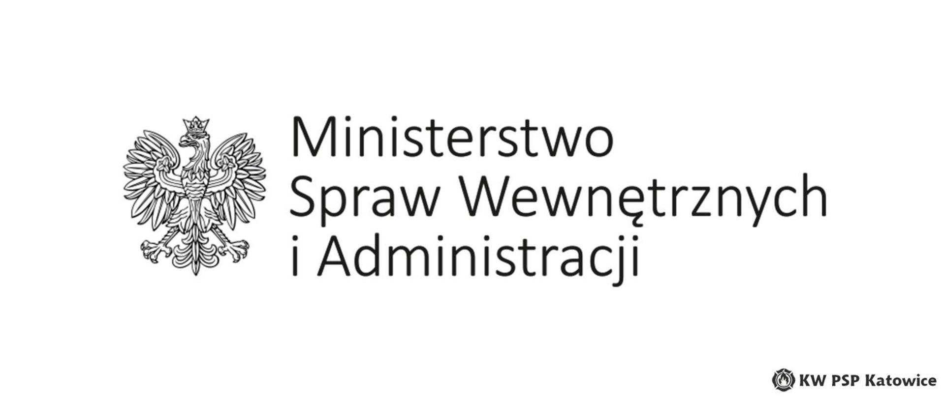 Ilustracja przedstawia na białym tle, na środku czarno-biały logotyp Ministerstwa Spraw Wewnętrznych, który składa się z czarno-białego orła oraz napisu Ministerstwo Spraw Wewnętrznych i Administracji. W prawym dolnym rogu napis KW PSP Katowice