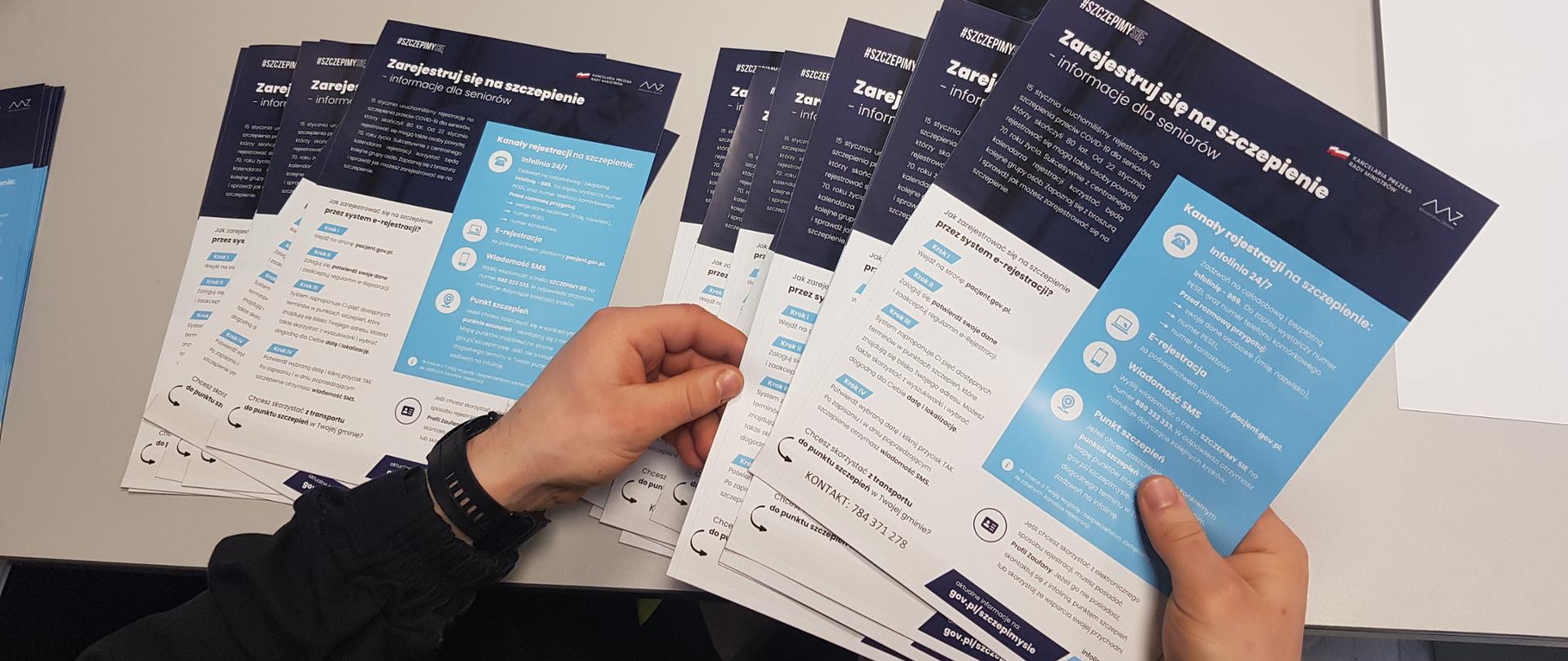 Ulotki rozłożone na stole.