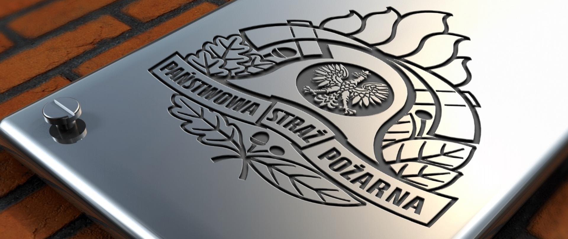 Logo PSP sygnowane na metalowej tablicy