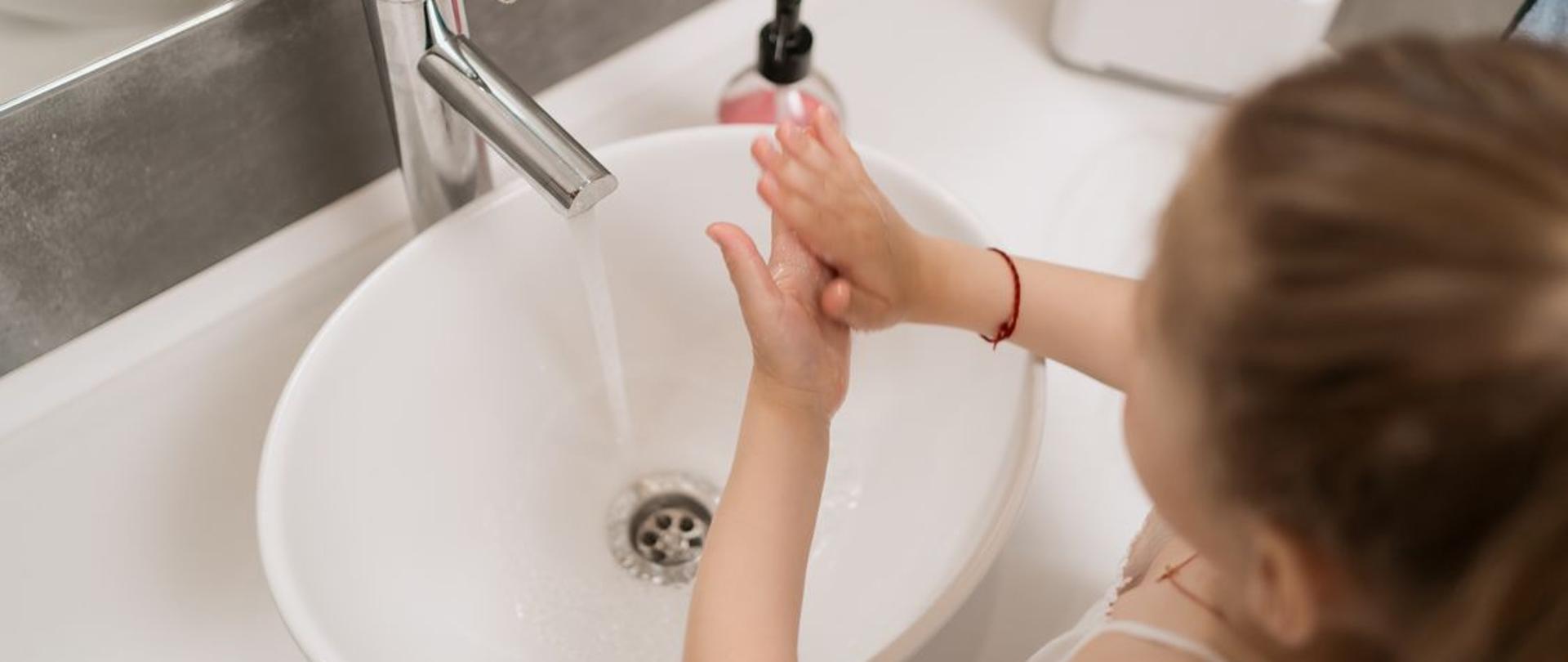 A cute little girl washing her hands. Protection against infections and viruses. hands higiene