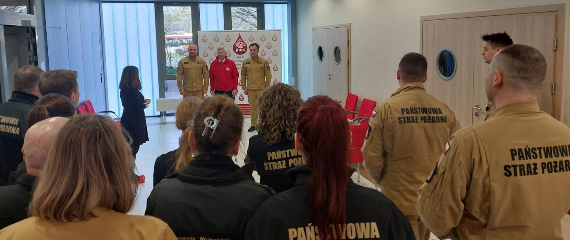 Uroczyste rozpoczęcie akcji przez p.o. Zastępcy Mazowieckiego Komendanta Wojewódzkiego PSP: st. bryg. Macieja Bieńczyka oraz st. bryg. Piotra Gąskę,w imieniu Mazowieckiego Komendanta Wojewódzkiego PSP st. bryg. Artura Gonery,. Przemówienia słuchają przybyli na akcję strażacy i pracownicy cywilni. 