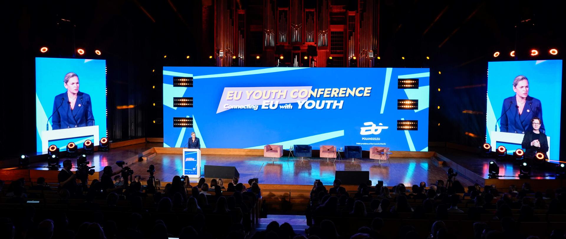 Minister Barbara Nowacka przemawia przy mównicy. Widok z góry widowni