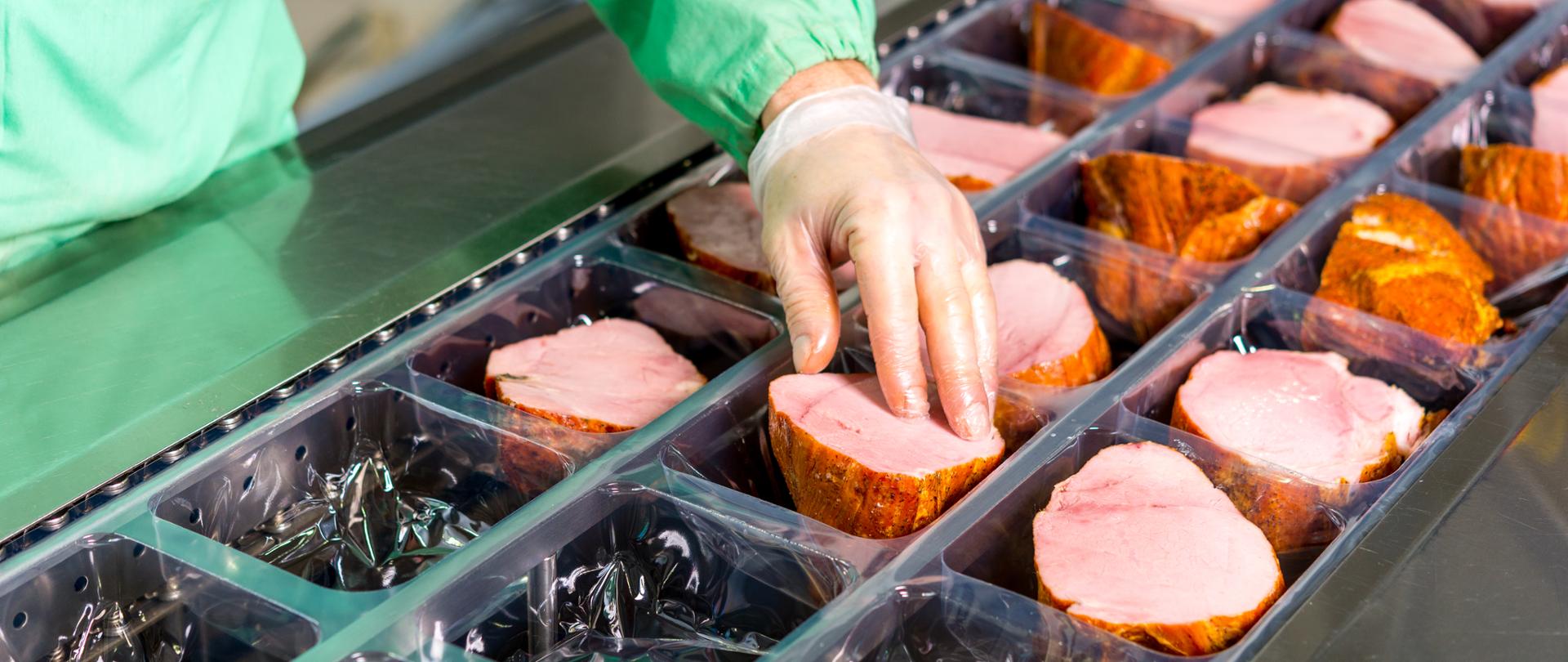 Several chunks of raw meat being processed packaged and shipped