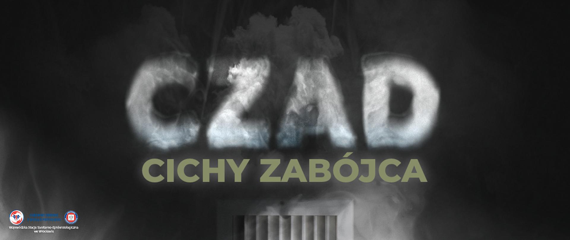 Napis "czad" utworzony z dymu nad kaloryferem na ciemnym tle