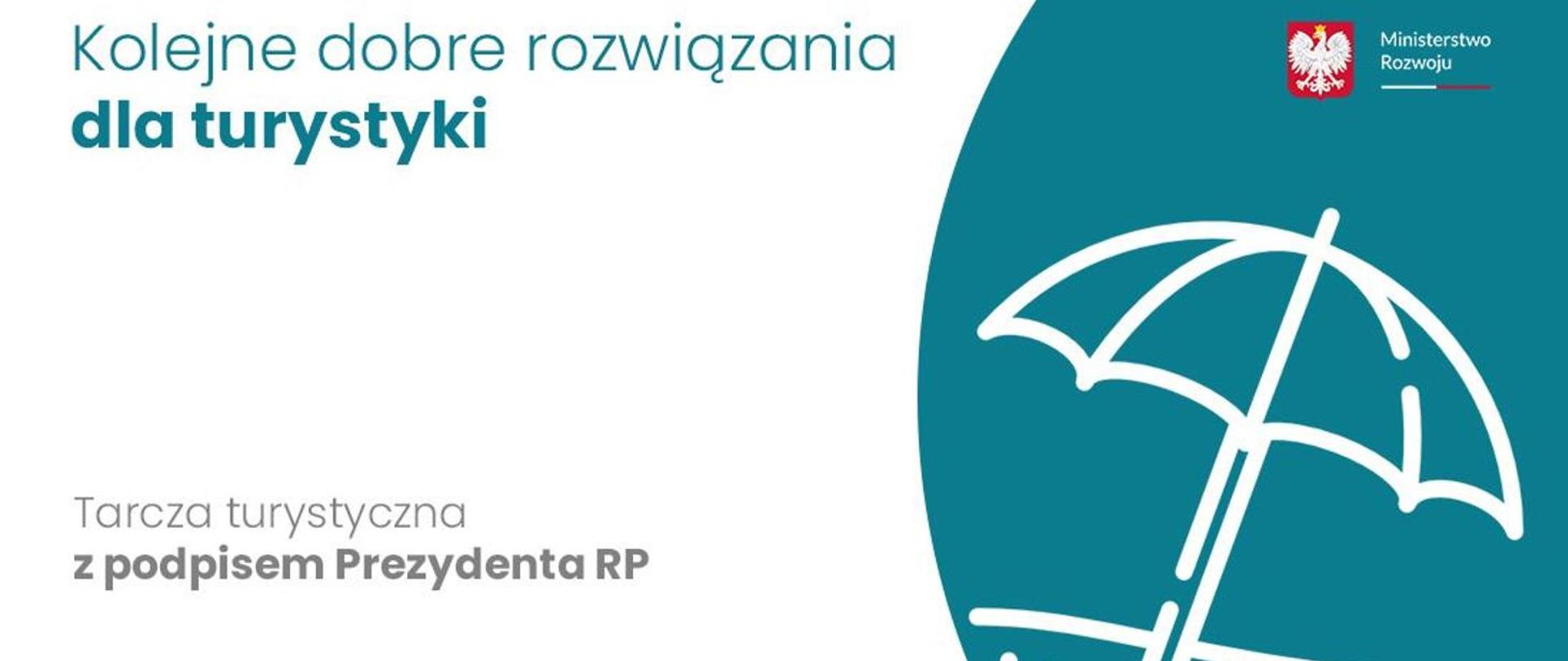 Napis: Tarcza Turystyczna z podpisem Prezydenta RP na biało-niebieskim tle 