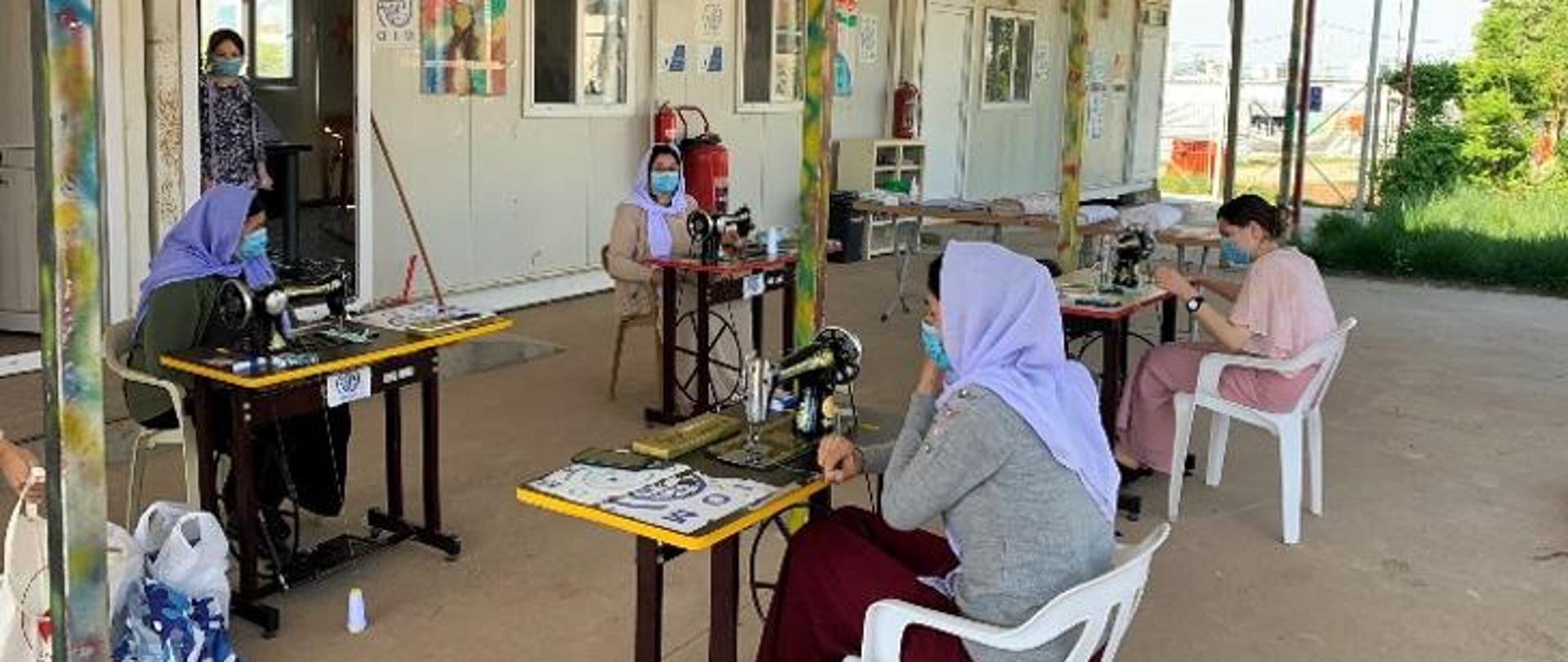 four women sewing protective masks