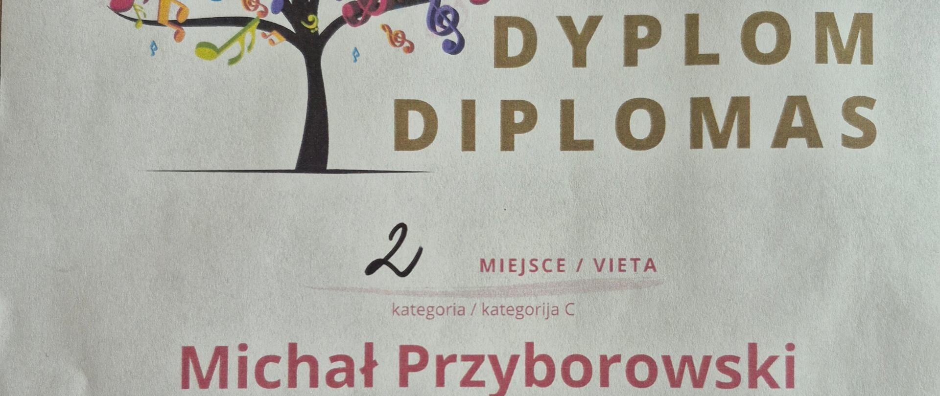 Dyplom z Międzynarodowego Konkursu Instrumentalnego w Puńsku. Dyplom przedstawia drzewo ozdobione różnego rodzaju kolorowymi nutami i kluczami muzycznymi. Z prawej złoty napis Dyplom w dwóch językach, Polskim i Litewskim. Na środku czerwonym kolorem 2 miejsce kategoria C i imię i nazwisko ucznia Michał Przyborowski. W lewym dolnym rogu podpisy jury. Na dole data 16-17 maja 2025 i miejscowość Puńsk.