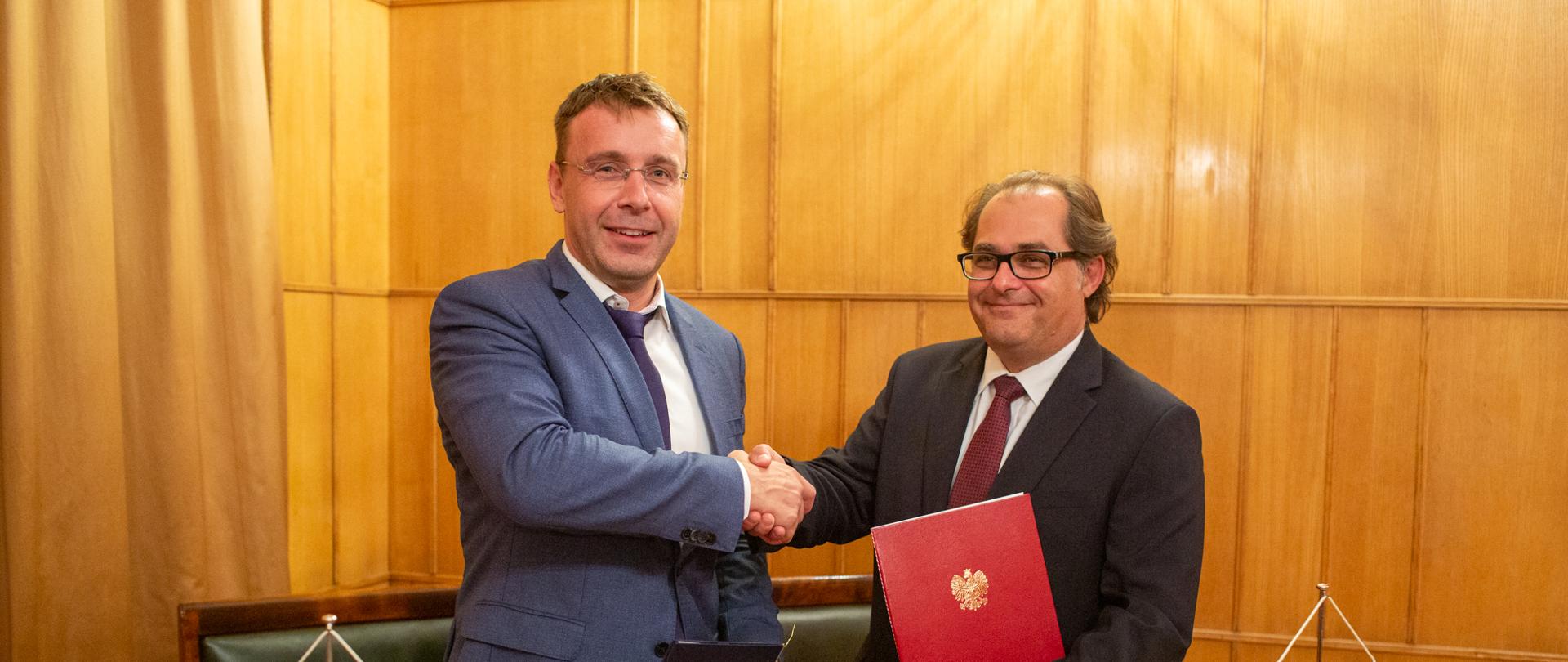 Uścisk dłoni ministrów po podpisaniu porozumienia. Minister Vladimir Kremlik (po lewej) i minister Marek Gróbarczyk (po prawej).