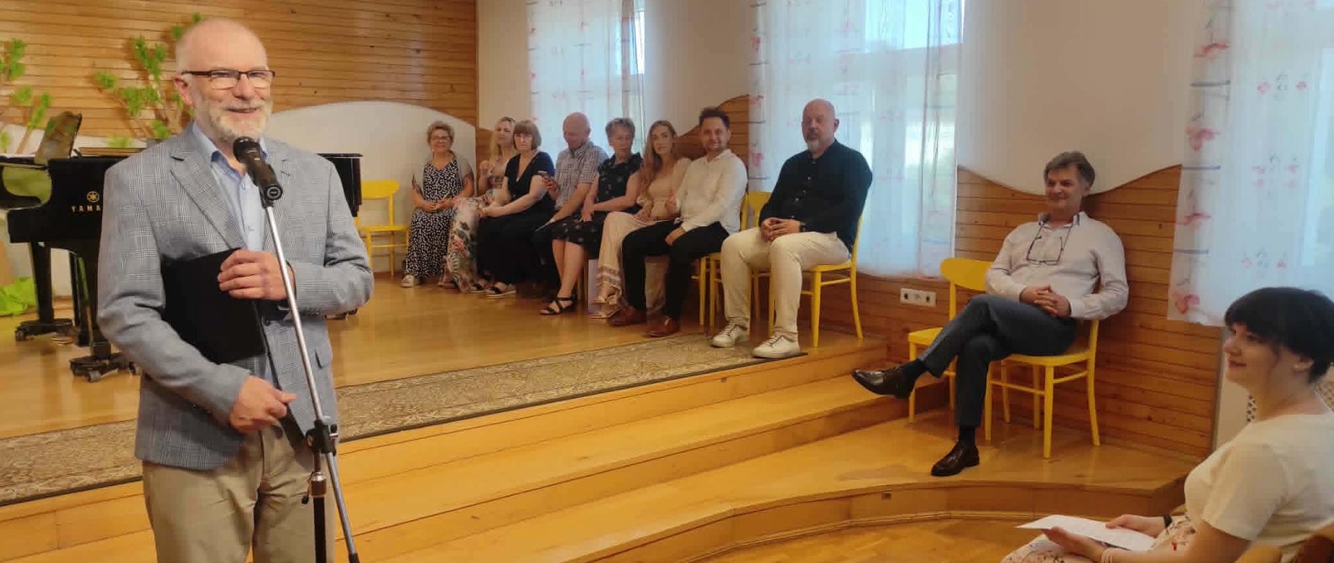 dyrektor mówiący do zgromadzonych uczniów, w tle nauczyciele