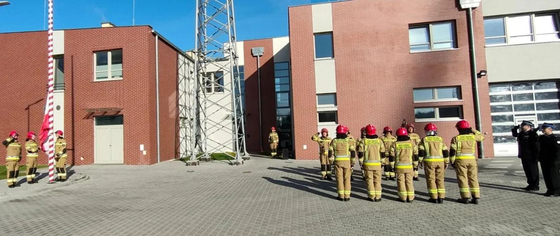 Widocznie na zdjęciu funkcjonariusze KP PSP Gryfice podczas uroczystej zmiany służby połączonej z podniesieniem flagi na maszt.