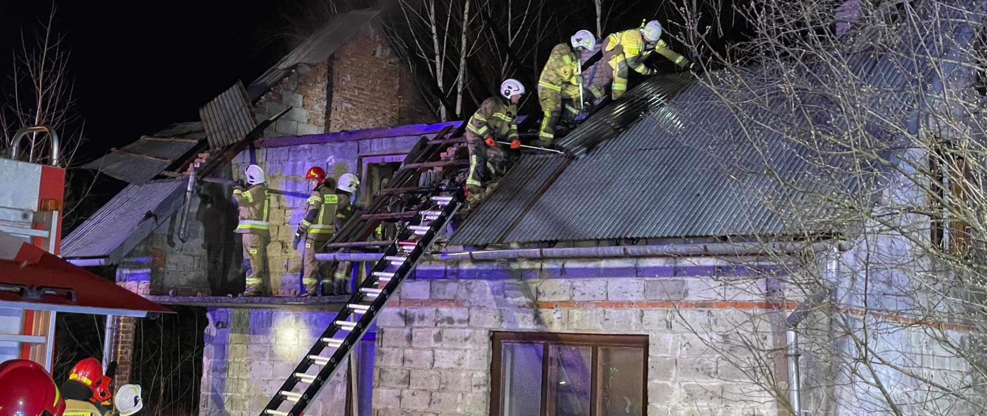 Strażacy prowadzą prace rozbiórkowe na dachu budynku
