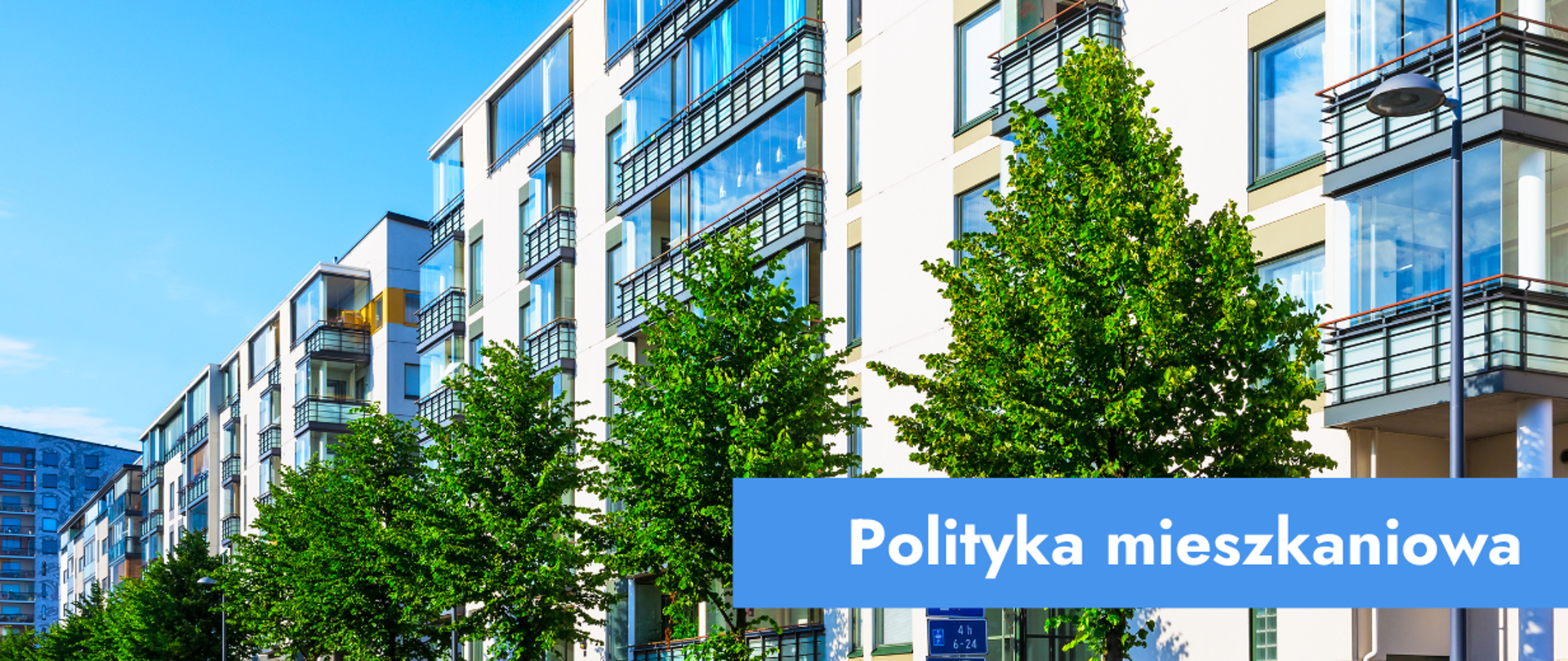 Grafika przedstawiająca osiedle bloków i napis: polityka mieszkaniowa