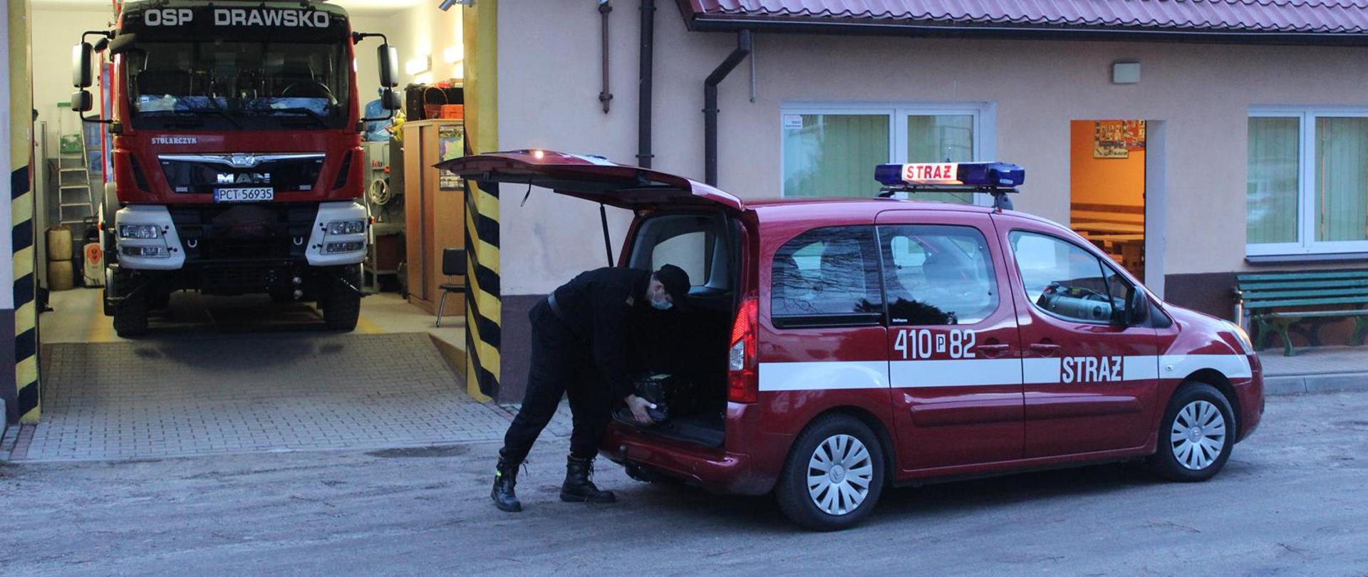 Strażak dostarcza ulotki do pobliskich OPS 