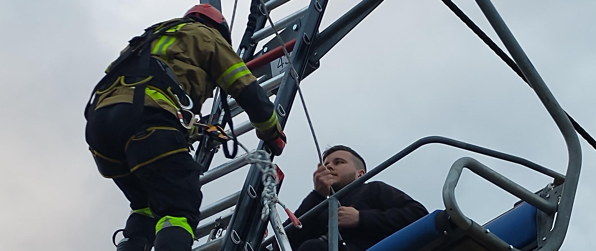 Ewakuacja osób z krzesełka kolei przy zastosowaniu drabiny przystawnej.