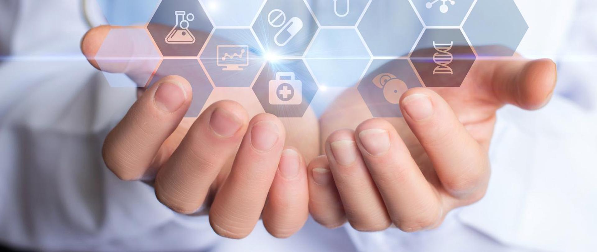 Dwie dłonie, nad nimi szare sześciokątne ikony z grafikami: apteczki, probówki, łańcucha DNA