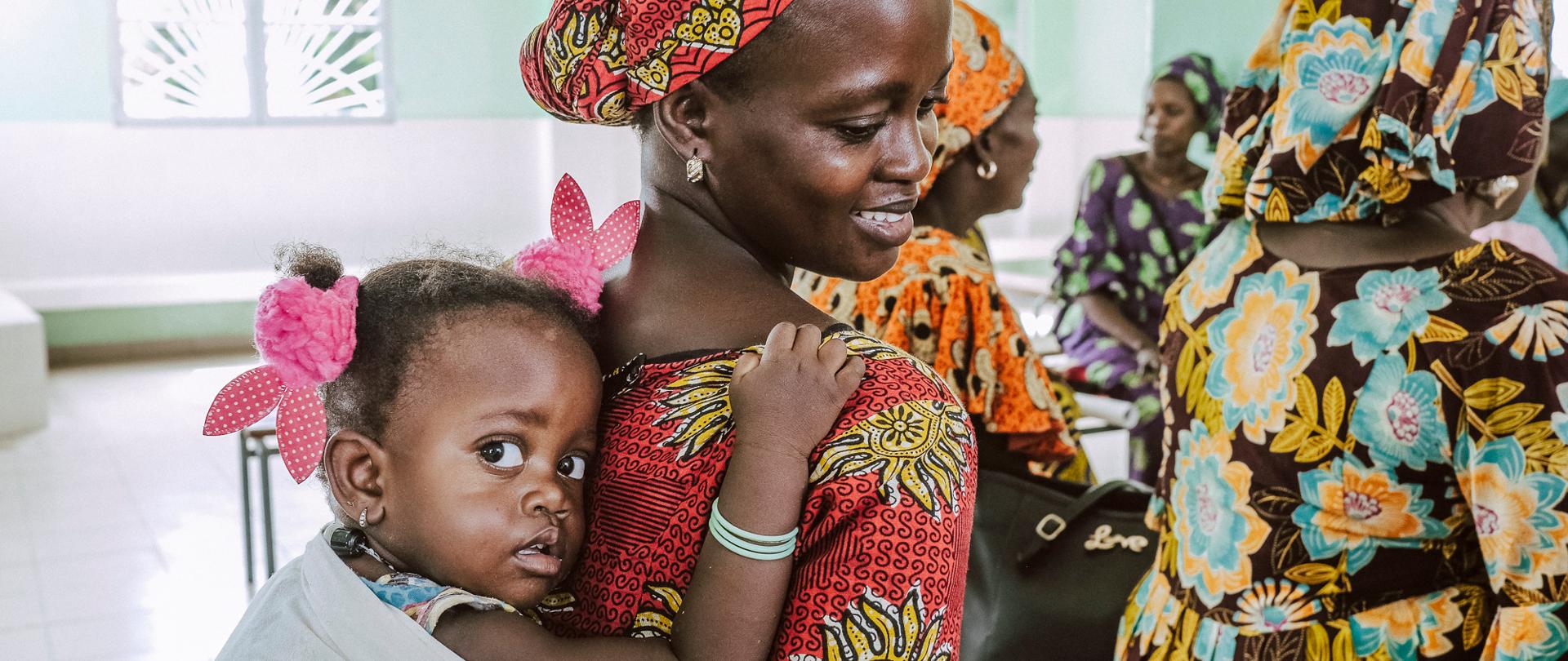 Kobieta z córeczką na plecach