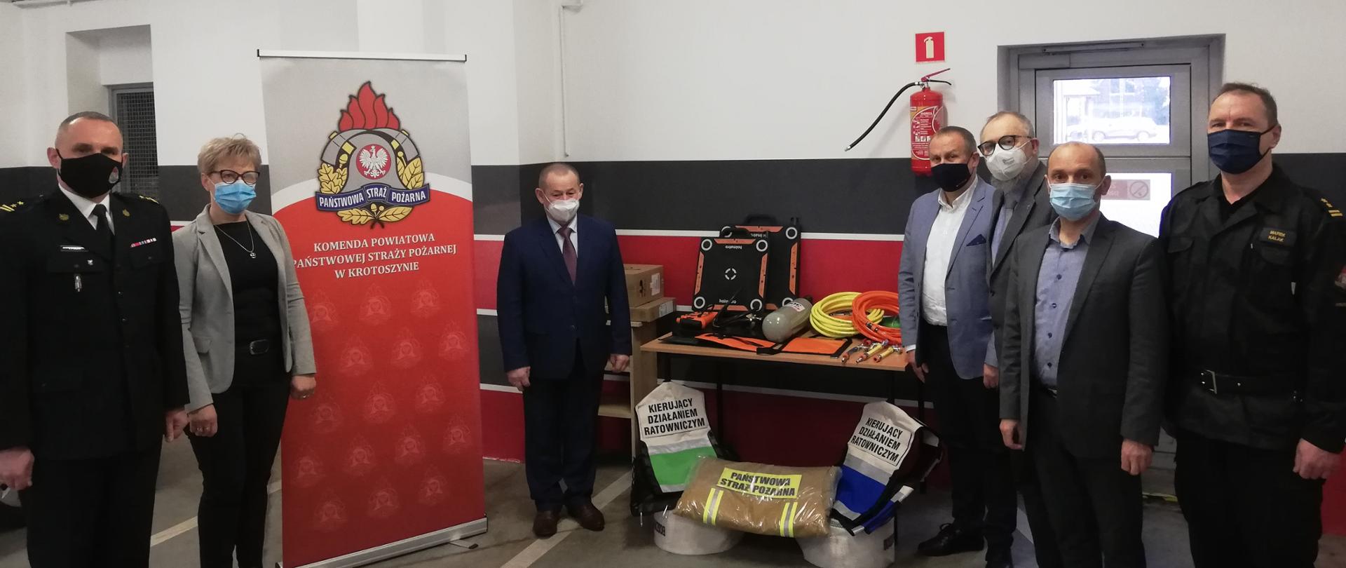 Zdjęcie przedstawia przedstawicieli samorządów lokalnych oraz komendanta powiatowego PSP w Krotoszynie wraz z zastępcą na tle przekazywanego sprzętu.