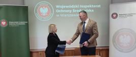 Uścisk dłoni po podpisaniu porozumienia między MWIOŚ a Dyrekotrem OUG w Warszawie