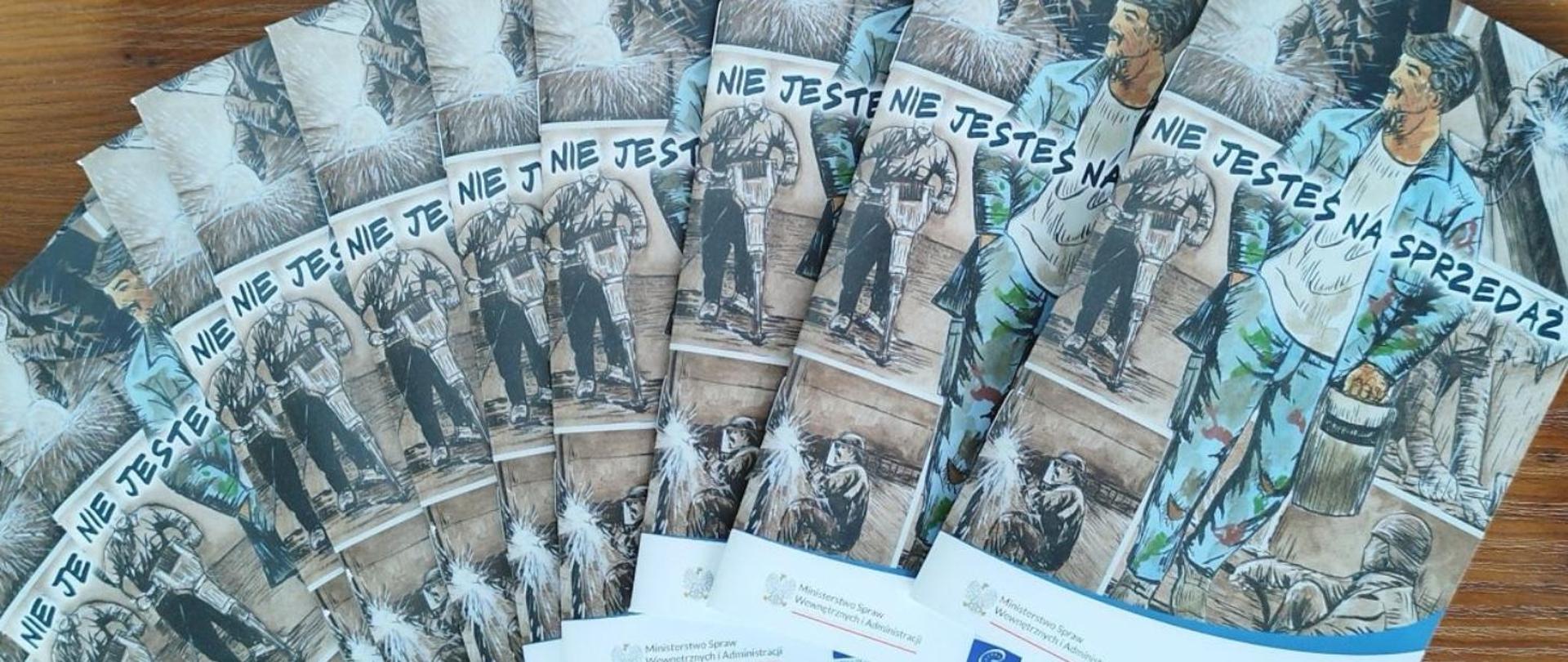 Na zdjęciu widoczne są ulotki dotyczące kampanii "Nie jesteś na sprzedaż".