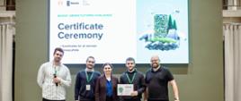 4 man and 1 women posing to photo with certificate of participation