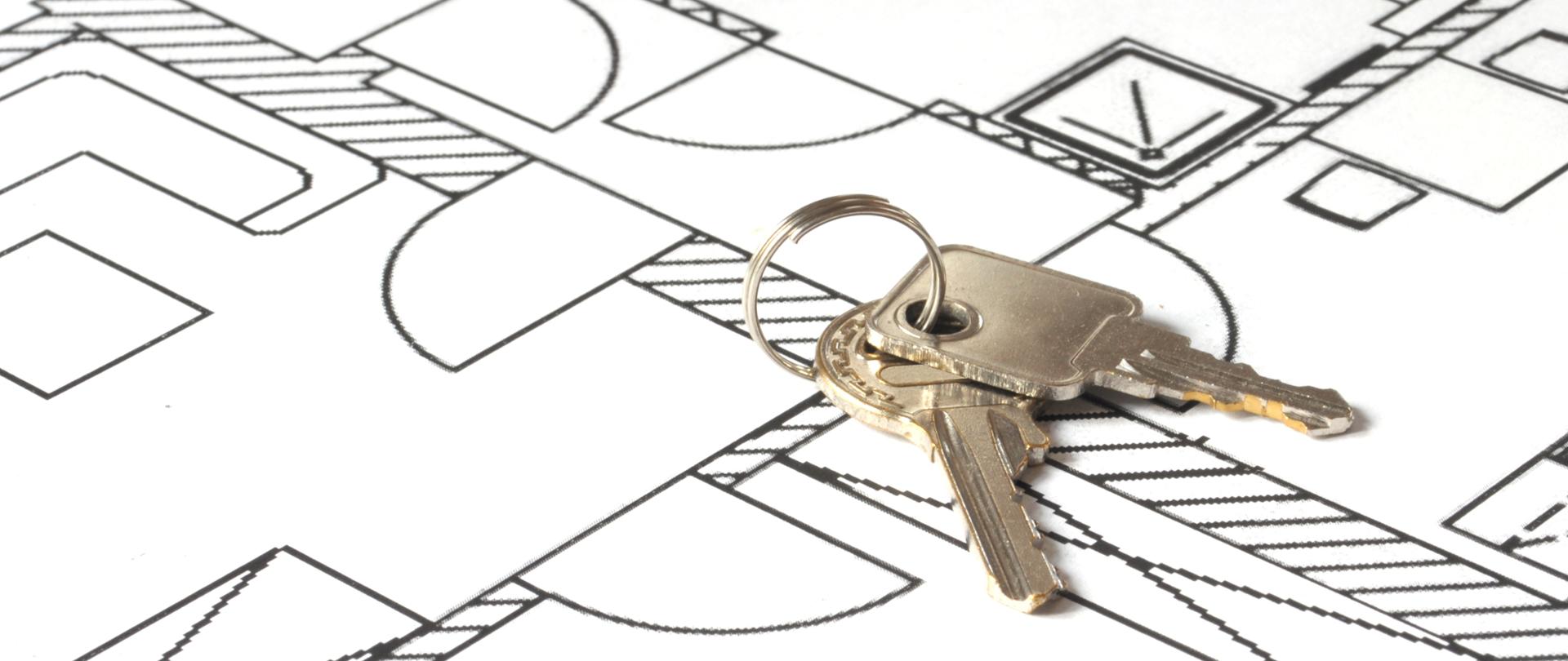 house key on a blueprint - relocate concept