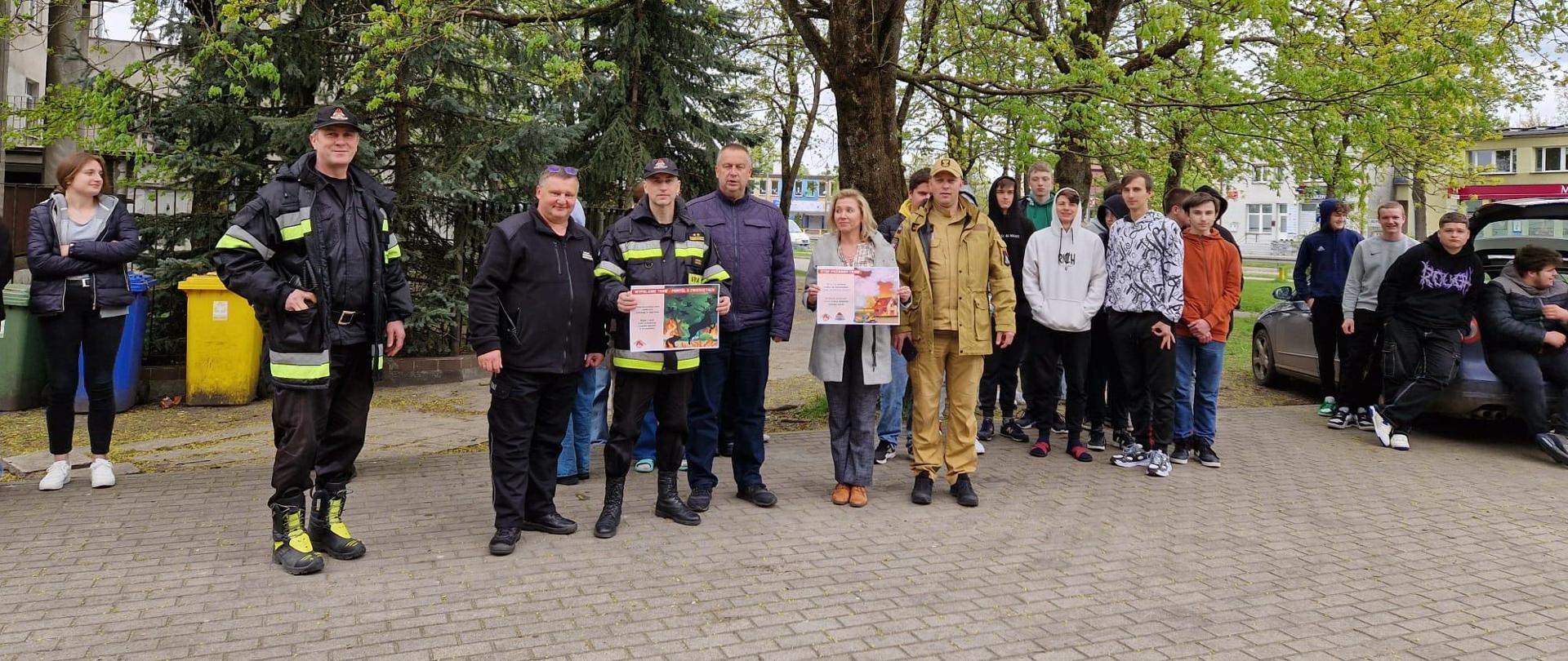 Strażacy prezentujący plakaty akcji STOP pożarom traw!!!