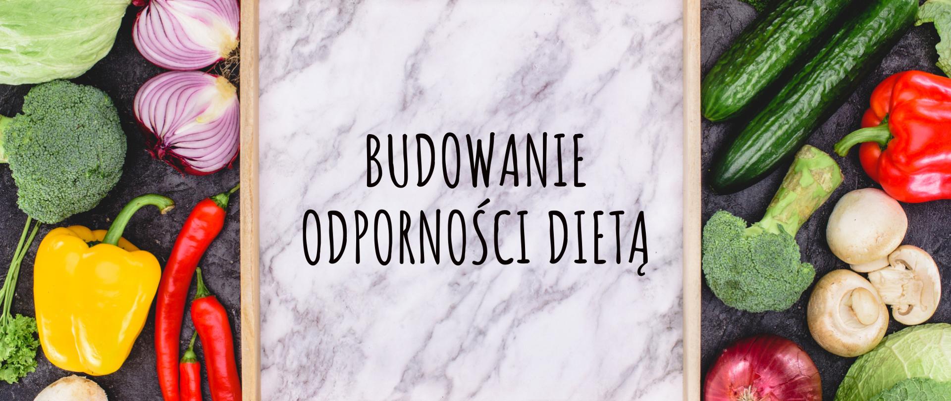 Na grafice są warzywa. W centrum znajduje się deska do krojenia, na której jest napisane BUDOWANIE ODPORNOŚCI DIETĄ.