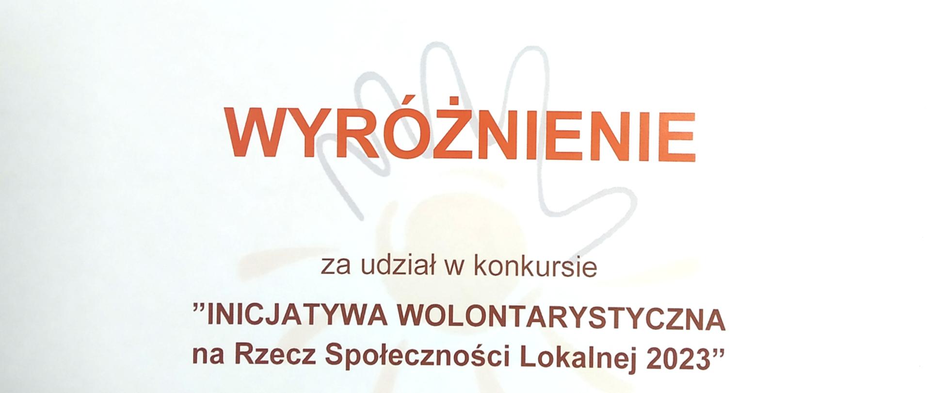 na białym tle napis wyróżnienie za udział w konkursie inicjatywa woluntarystyczna na rzecz społeczności lokalnej 2023, w tle dłoń 