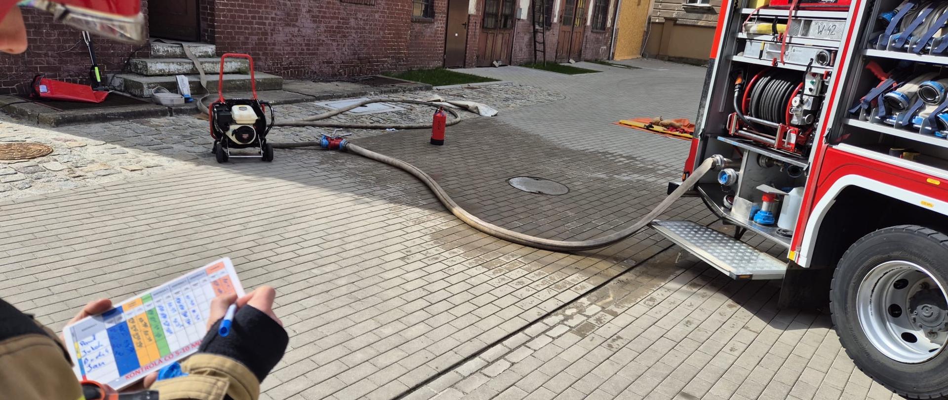Strażak zapisuje wartości na tabliczce do zarządzania powietrzem