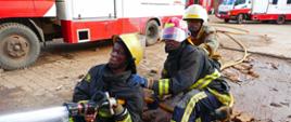 Three firemen are holding fire hose - they are trained to stop fire