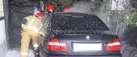 Strażacy podczas gaszenia samochodu osobowego marki BMW