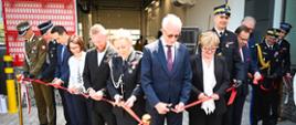 Przedstawiciele władz państwowych, samorządowych oraz PSP przecinają czerwoną wstęgę podczas symbolicznego otwarcia nowej siedziby KP PSP i JRG w Brzozowie.