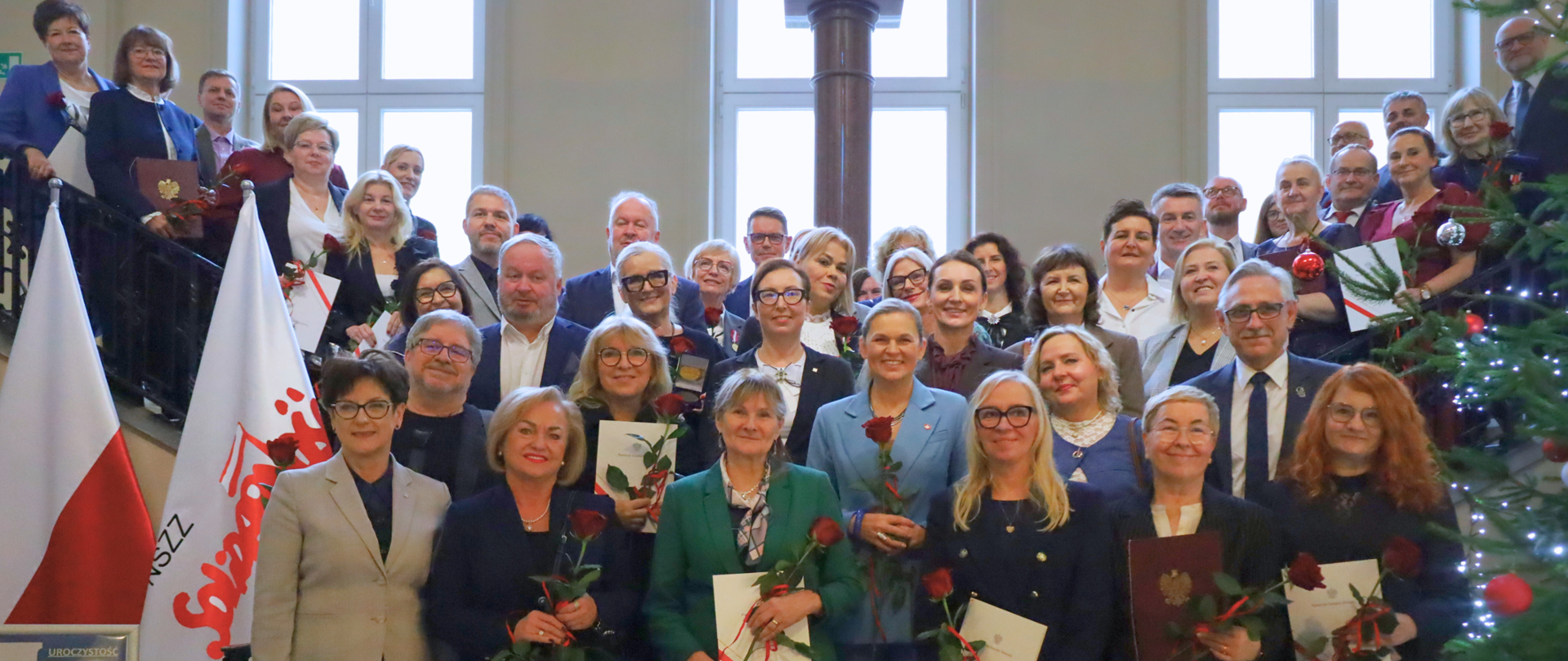 grupa kilkudziesięciu nauczycieli pozuje do zdjęcia w budynku urzędu wojewódzkiego