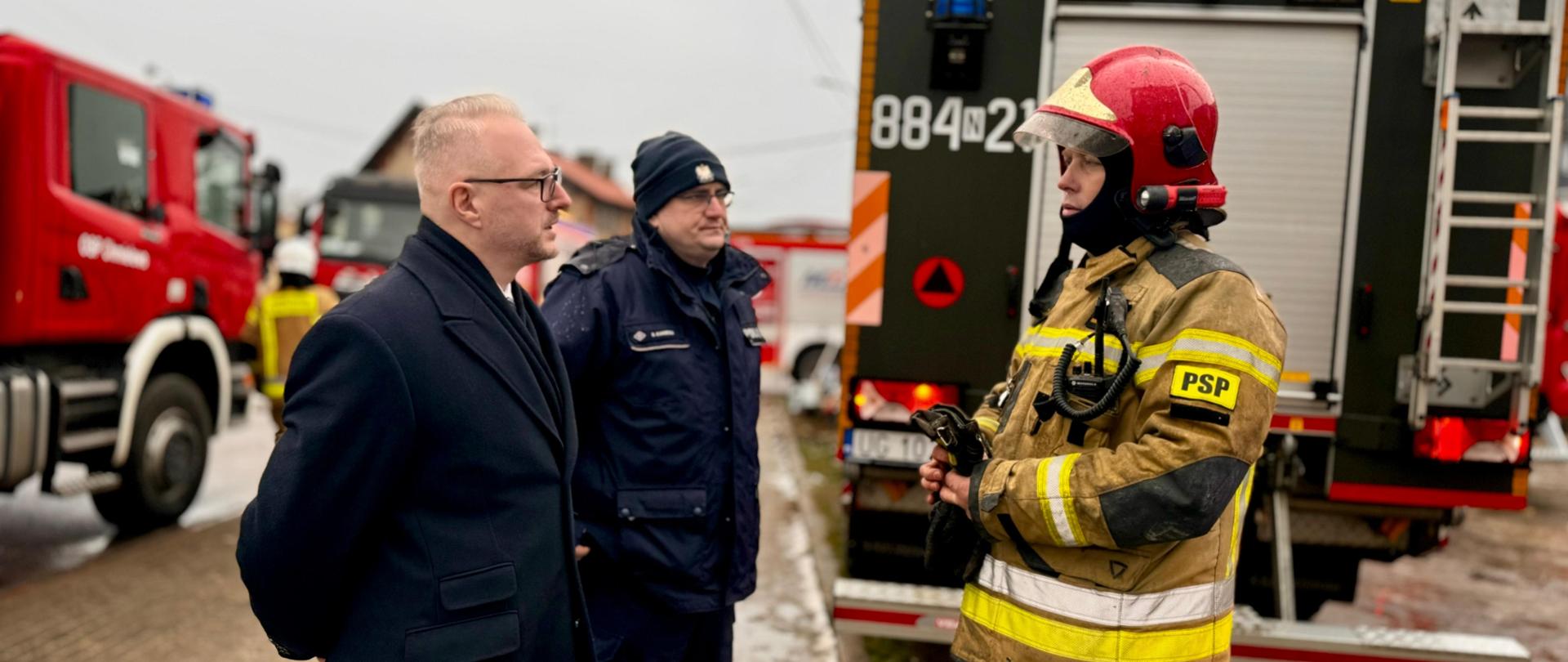 Wybuch gazu i pożar w budynku wielorodzinnym w Orzyszu w dniu 7 stycznia 2025 r. rozmowa wojewody Radosława Króla z funkcjonariuszami Straży Pożarnej i Policji.