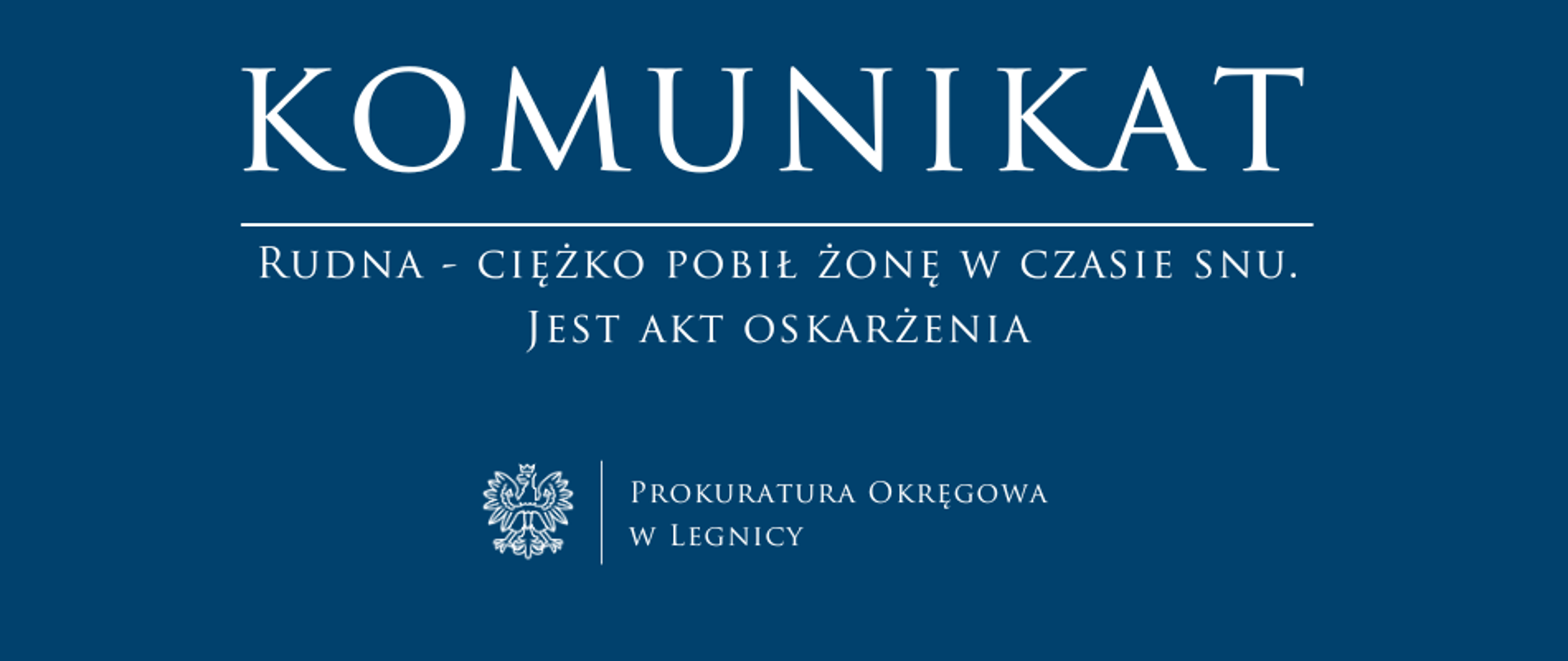 baner - na niebieskim tle napis w kolorze białym Komunikat, poniżej pozioma biała kreska, pod kreską napis "Rudna - ciężko pobił żonę w czasie snu. Jest akt oskarżenia", niżej pośrodku rysunek orła oddzielony od napisu Prokuratura Okręgowa w Legnicy krótką pionową kreską 