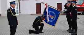 na zdjęciu widać przejmowanie obowiązków przez komendanta powiatowego ucałowanie sztandaru