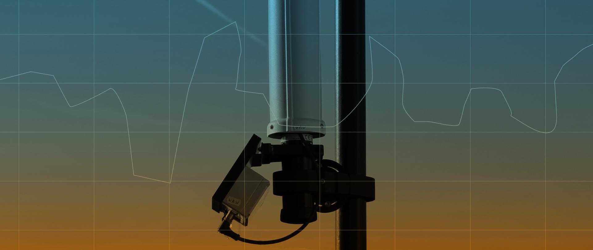 Element graficzny - przyrząd NARDA służący do pomiaru pola elektromagnetycznego.