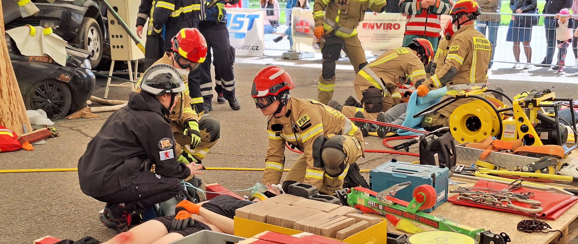 Drużyna strażaków wykonuje czynności ratunkowe w czasie działań ratowniczych podczas ćwiczenia w czasie zawodów