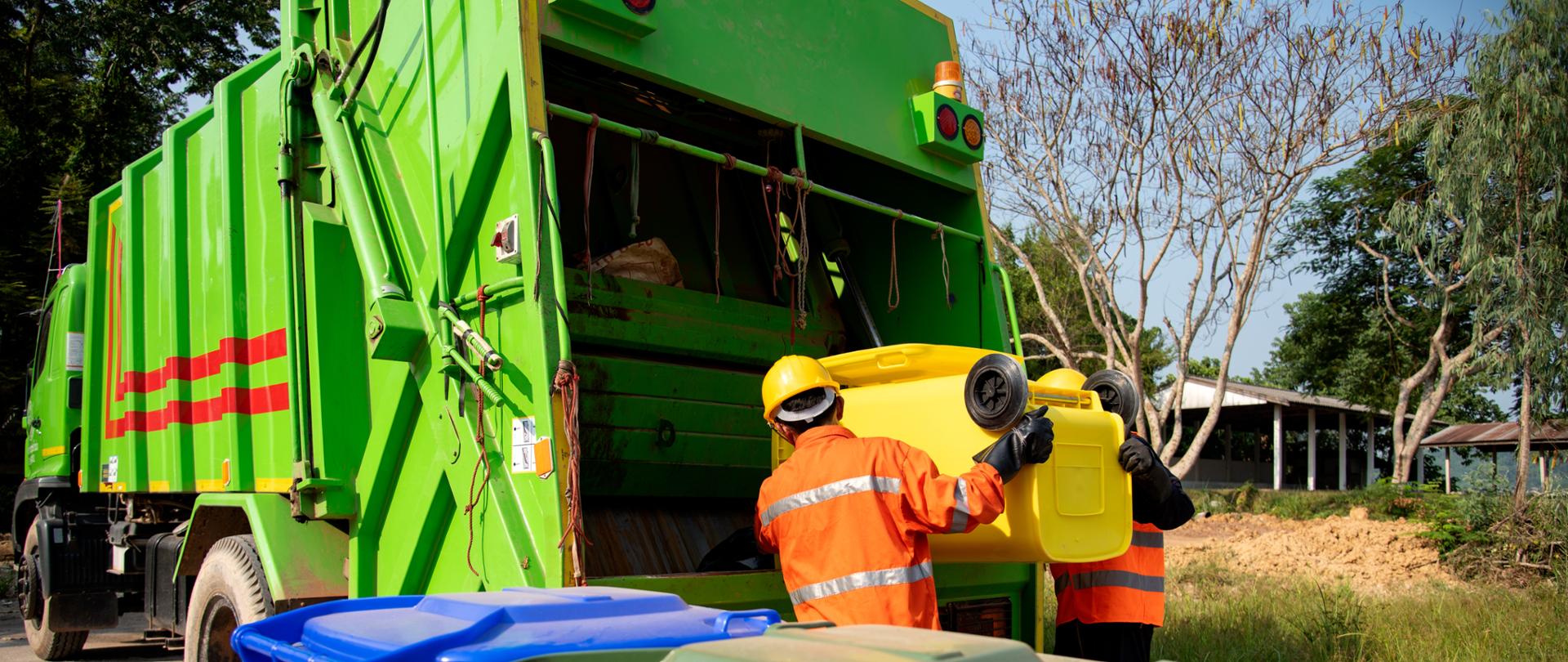 Garbage collector Worker of urban municipal recycling garbage collector truck loading waste and trash bin