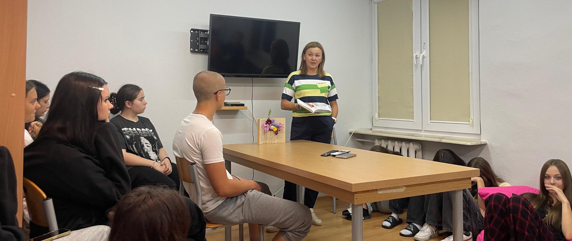 W sali pełnej mieszkańców internatu odbywa się Narodowe Czytanie prowadzone przez panią Krystynę Stefaniuk
