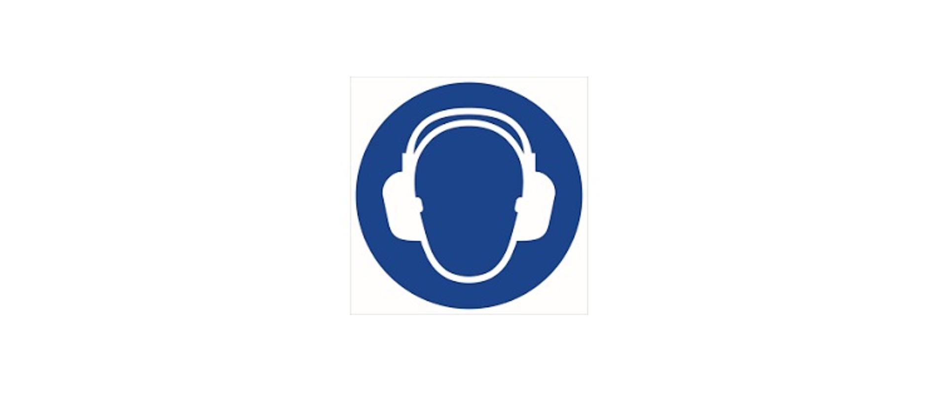Grafika przedstawia ciemnoniebieski okrąg, wewnątrz którego znajduje się narysowany białą linią szkic głowy człowieka z założonymi na uszy słuchawkami ochronnymi. 